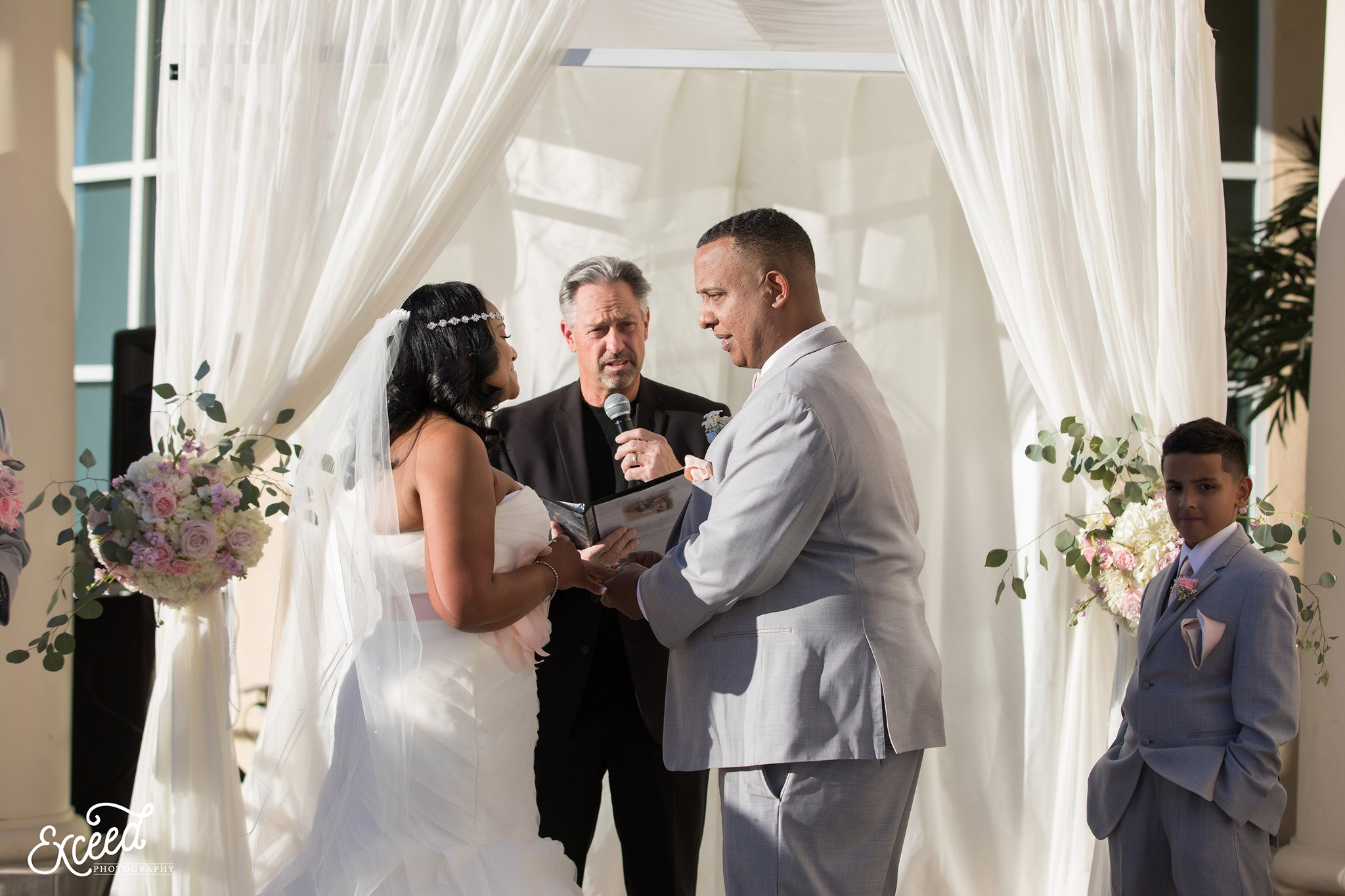 Bride and groom exchanging ring at the Canyon Gate Country Club 
