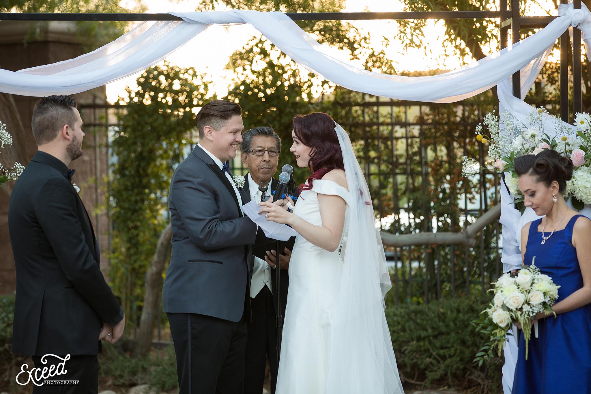 bride and groom exchanging wedding vows at DragonRidge Country Club Wedding